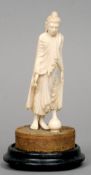 A 19th century Indian ivory group
Carved as a deity, stood before a vase, standing on a fabric