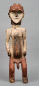 A large carved wooden tribal fertility figure
Modelled standing with painted decoration.  70 cms