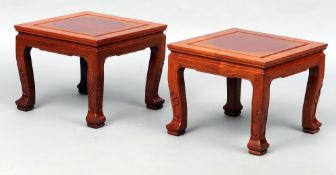 A pair of Chinese hardwood stands
Each square section panelled top above a shaped frieze with carved