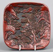 A small 19th century Chinese cinnabar lacquered dish
Of rounded square form decorated with pagodas