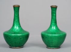 A pair of small Chinese cloisonne vases
Each green ground vessel decorated with flowers.  Each 9 cms