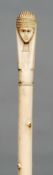 A 19th century ivory walking cane
Of segmented shaft beneath the Egyptian bust carved handle.  90