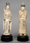 A pair of Chinese carved ivory figures of an emperor and empress
Each wearing intricately designed