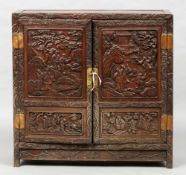 A 19th century Chinese carved hardwood side cabinet
The panelled top above the two profusely