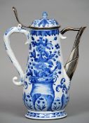 An 18th century Chinese Kangxi blue and white porcelain and white metal mounted coffee pot
The