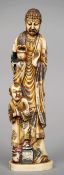 An Oriental carved ivory figural group
Formed as a priestly figure and a small boy, each dressed