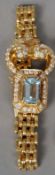 An 18 ct gold diamond and aquamarine set bracelet
The central aquamarine bordered by approximately 4