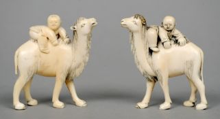 A pair of Chinese carved ivory figural groups
Each formed as a young boy mounting a camel.  Each 7