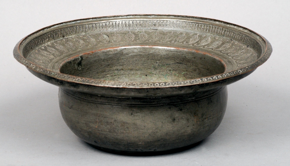 A 19th century Eastern silvered copper bowl
The deep vessel with a broad stepped rim with engraved