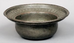 A 19th century Eastern silvered copper bowl
The deep vessel with a broad stepped rim with engraved