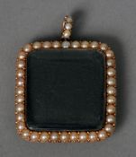 A Victorian 9 ct gold seed pearl mounted locket
Of square form, with opposing lenses.  3.5 cms wide.