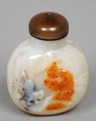 A Chinese carved agate snuff bottle
Carved to one side with a figure and a beast, the other side