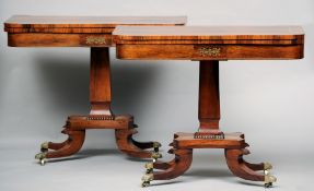 A pair of Regency brass inlaid rosewood card tables
Each hinged rounded rectangular top enclosing