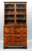 An early 19th century brass inlaid mahogany secretaire bookcase
The moulded rectangular top above