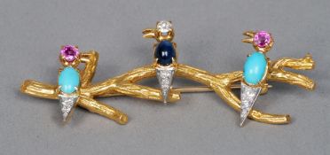 An 18 ct gold diamond, ruby, sapphire and turquoise set bar brooch
Formed as three birds perched