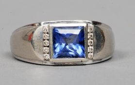 A 10 ct white gold and diamond ring
The two rows of five small diamonds flanking a central blue