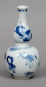 A Chinese porcelain double gourd vase
Decorated in underglaze blue with dancing boys.  15.5 cms