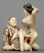 An Oriental carved ivory erotic figural group
The two detachable figures seated in a joyful