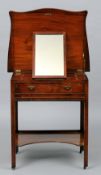 A George III mahogany gentleman's dressing table
The serpentine hinged top enclosing six hinged