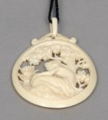 A late 19th/early 20th century ivory pendant
Of oval form, the centre pierced and carved with a