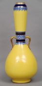 A 19th century Christopher Dresser style Mintons twin handled bottle vase
The yellow body with