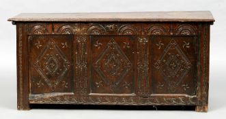 An 18th century oak panelled coffer
The moulded rectangular top above the carved three panelled