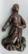An 18th century Continental carved figure of a Saint
Modelled kneeling holding a sacred heart.  62