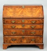 An 18th century walnut bureau
With fall front enclosing a fitted interior above four long