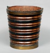 A 19th century Continental coopered walnut bucket
Of typical ribbed form with swing handle.  31