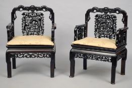 A set of four Chinese carved hardwood open armchairs
The shaped carve top rail above the pierced