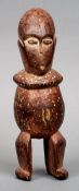 A 19th century tribal carved wooden figure
With punctured decoration.  24 cms high.   CONDITION