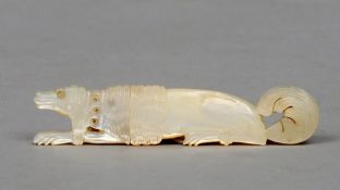 A 19th century mother-of-pearl needle case
Modelled as a recumbent hunting poodle, the collar