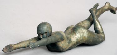 An Art Deco silvered bronze figure
Modelled nude but wearing a hat, arms outstretched to support a