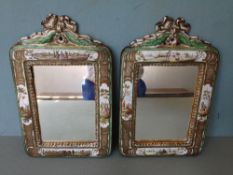 A pair of 19th century Continental enamel decorated porcelain mirrors
Each decorated with various