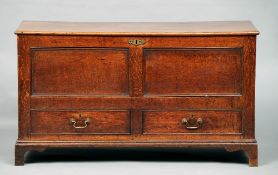 A George III oak mule chest
The hinged top enclosing a candle box with secret drawers, the twin