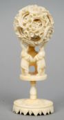 A 19th century carved ivory puzzle ball and stand
Of typical form, supported on three elephants.