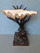 A 19th century marine inspired centrepiece
The natural shell bowl supported on the bronze rockwork
