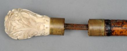 A 19th century sword stick
The bamboo cane enclosing a blade with foliate carved ivory knop handle.