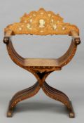 A 19th century Milanese ivory inlaid folding X-frame chair
The shaped back with central figural bust