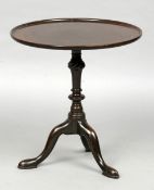 A 19th century mahogany tilt-top tripod table
The dished top above the turned column, standing on