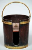 A Georgian mahogany plate bucket
Of tapering cylindrical form with a brass loop handle and twin