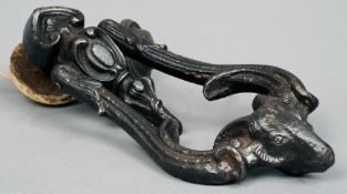 A 19th century cast iron door knocker
Of scroll cast form terminating in a ram' s head.  23 cms
