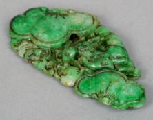 A Chinese spinach jade pendant
Carved with a deer amongst scrolling foliage. 8.5 cms wide.