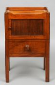 A 19th century mahogany bedside commode
The galleried top above the tambour fronted door and