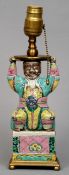 An 18th century Chinese porcelain figure
Seated wearing colourful robes, with later lamp