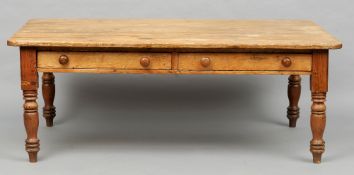 A large 19th century pine farmhouse kitchen table
The rounded rectangular top above a pair of full