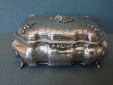 A 19th century Continental silver box
Of shaped rectangular form, the hinged cover with applied