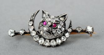 A unmarked gold, diamond and ruby bar brooch
Centrally set with a fox head above a crescent moon.