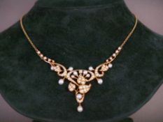 An Edwardian unmarked gold, diamond and seed pearl set necklace
The front formed as scrolling floral