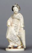 A late 19th/early 20th century Japanese ivory okimono
Formed as a kimono wearing lady holding a